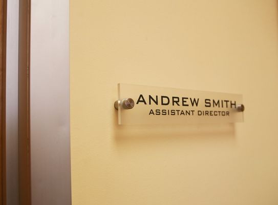 曇らされた背景の終わりを用いる無臭のアクリルの単語の印のオフィスの壁の名札